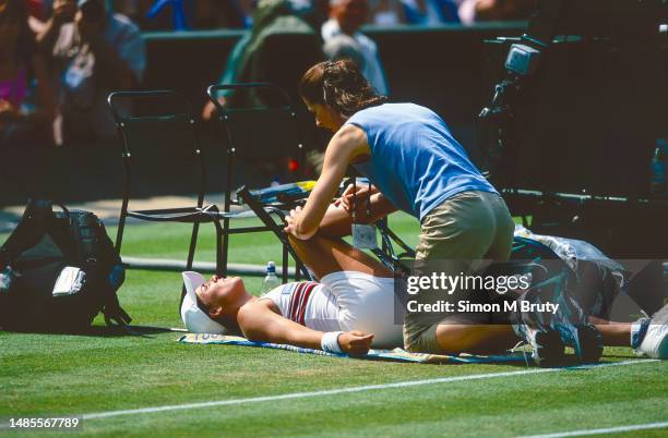 Jennifer Capriati from the USA gets treatment during her game against Serena Williams of the USA at The Wimbledon Lawn Tennis Championship at the All...