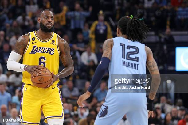 LeBron James of the Los Angeles Lakers handles the ball against Ja Morant of the Memphis Grizzlies during the first half of Game Five of the Western...