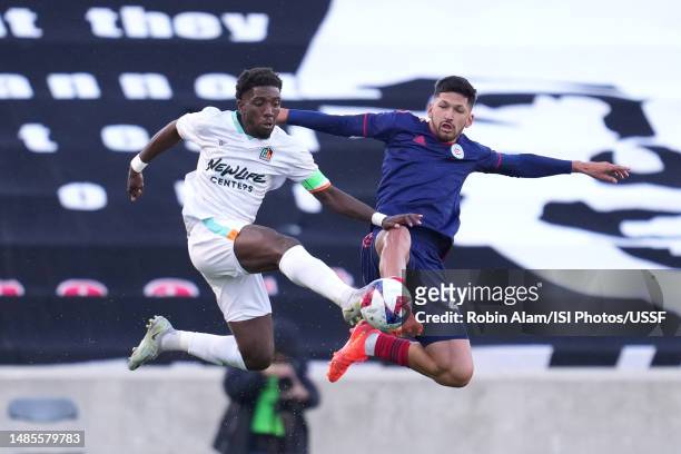 Chicago House AC midfielder Anthony Smith Jr. Battles with Chicago Fire defender Mauricio Pineda for the ball during the 2023 U.S. Open Cup third...