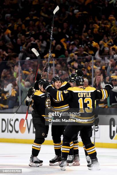 Taylor Hall of the Boston Bruins celebrates with Dmitry Orlov, Brandon Carlo and Charlie Coyle of the Boston Bruins after scoring a goal on Sergei...