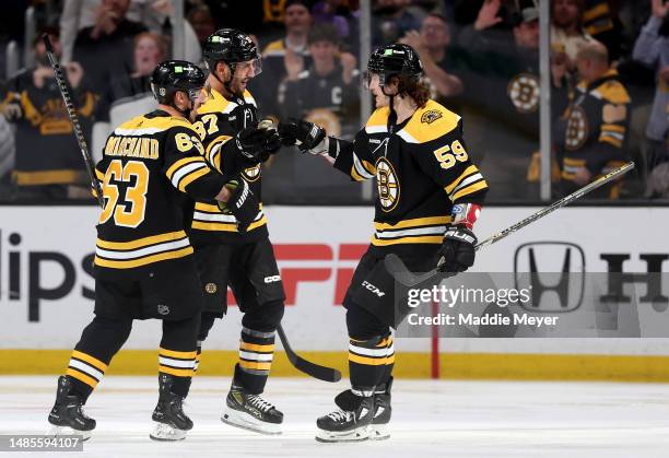 Patrice Bergeron of the Boston Bruins celebrates with Tyler Bertuzzi and Brad Marchand after scoring a goal on Sergei Bobrovsky of the Florida...