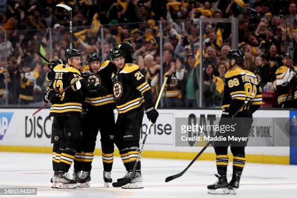 Taylor Hall of the Boston Bruins celebrates with Dmitry Orlov, Brandon Carlo, Charlie Coyle and David Pastrnak after scoring a goal on Sergei...