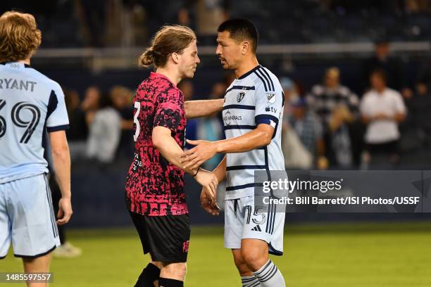 Jonathan Harris of Tulsa Athletic shakes hands with Roger Espinoza of Sporting Kansas City at the end of the game at Children's Mercy Park on April...