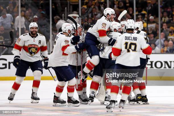 Matthew Tkachuk of the Florida Panthers celebrates with his teammates after scoring the game winning goal against Linus Ullmark of the Boston Bruins...