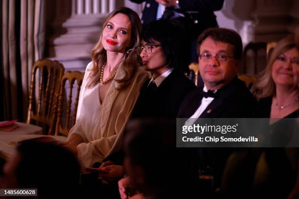 Actress Angelina Jolie and her son her son Maddox listen to Norm Lewis perform during the South Korean state dinner at the White House on April 26,...