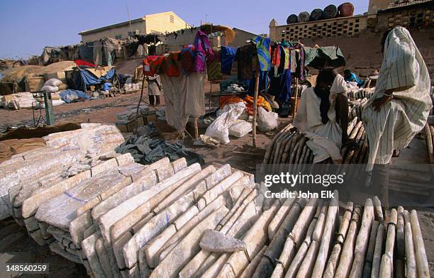 selling slabs of salt at the mopti salt market. most likely this merchandise has travelled by boat along the niger river from timbuktu. - mopti stock pictures, royalty-free photos & images