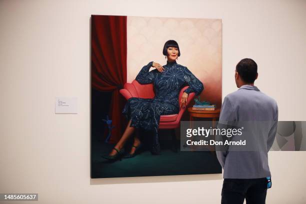 Man views Sally Ryan's portrait of Claudia Chan Shaw 'Year of the Rabbit' during the 2023 Packing Room Prize announcement on April 27, 2023 in...