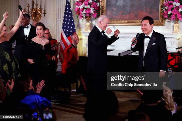 President Joe Biden cheers as South Korean President Yoon Suk-yeol sings "American Pie" by Don McLean during a state dinner at the White House, April...