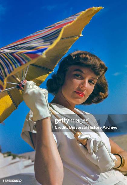 Young Woman in White Dress with Sun Umbrella, Toni Frissell Collection, 1946.