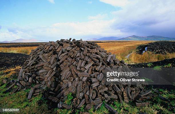 peat harvest: a pile of fuel for the fires - county kerry - peat stock pictures, royalty-free photos & images