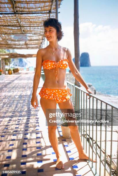Woman wearing Orange Two-Piece Bathing Suit with Polka Dots, Capri, Italy, Toni Frissell Collection, June 1959.
