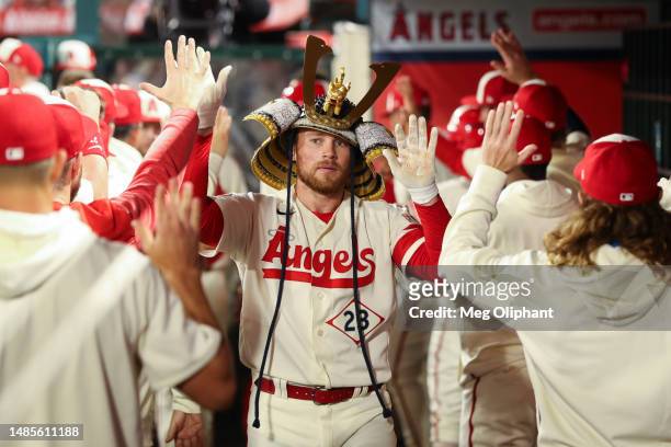 Brandon Drury of the Los Angeles Angels celebrates his two-run home run with teammates in the dugout in the fifth inning against the Oakland...