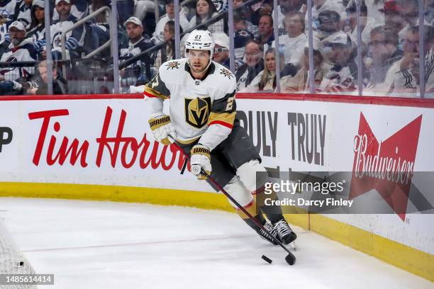 Shea Theodore of the Vegas Golden Knights plays the puck around the net during second period action against the Winnipeg Jets in Game Three of the...