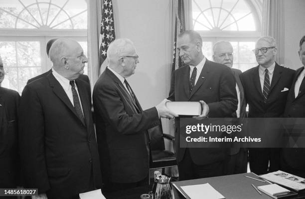 The Warren Commission presents their findings on the assassination of President John F Kennedy, the Warren Report, to American President Lyndon B...