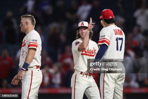 Brett Phillips, Mike Trout and Shohei Ohtani of the Los Angeles Angels celebrate an 11-3 win over the Oakland Athletics at Angel Stadium of Anaheim...