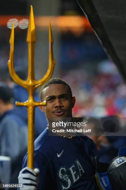 Julio Rodriguez of the Seattle Mariners reacts with the trident in the dugout after hitting a solo home run in the top of the second inning against...