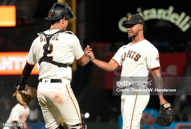 Camilo Doval and Blake Sabol of the San Francisco Giants celebrates defeating the St. Louis Cardinals 7-3 at Oracle Park on April 26, 2023 in San...