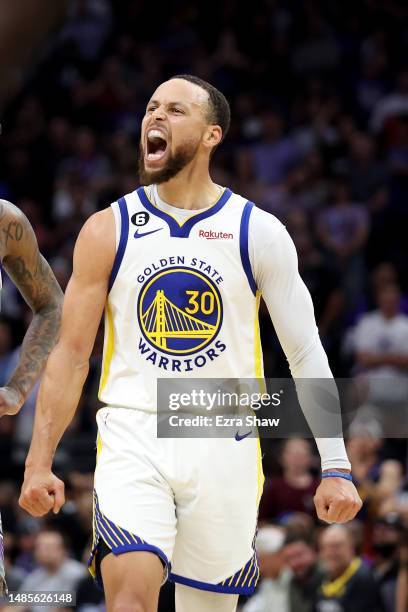 Stephen Curry of the Golden State Warriors reacts after making a basket and getting fouled by the Sacramento Kings during the second half of Game...