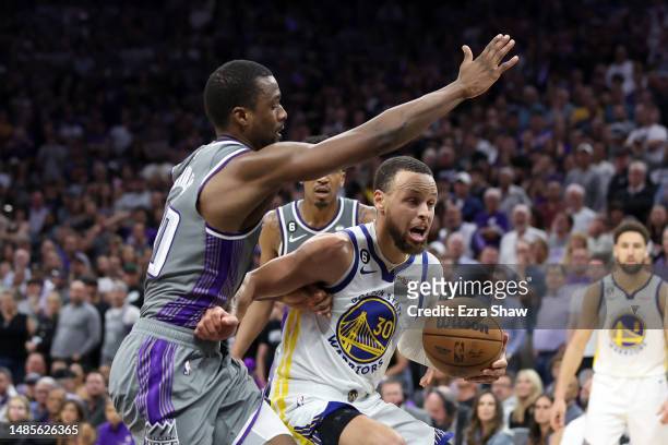Stephen Curry of the Golden State Warriors is guarded by Harrison Barnes of the Sacramento Kings during the second half of Game Five of the Western...