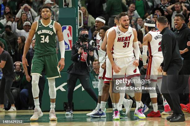 Max Strus and members of the Miami Heat celebrate in front of Giannis Antetokounmpo of the Milwaukee Bucks after winning Game 5 of the Eastern...