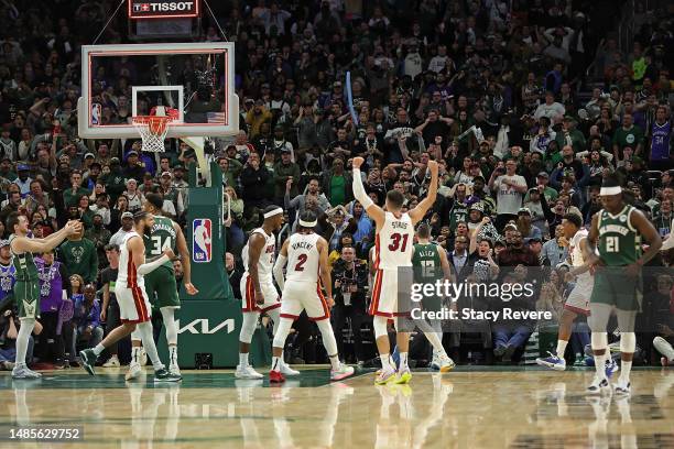 Members of the Miami Heat celebrate after defeating the Milwaukee Bucks in overtime of Game 5 of the Eastern Conference First Round Playoffs at...