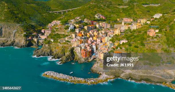 beautiful landscape of a coastal fishing village, city of the cinque terre in riomaggiore, italy, europe. - riomaggiore stock pictures, royalty-free photos & images