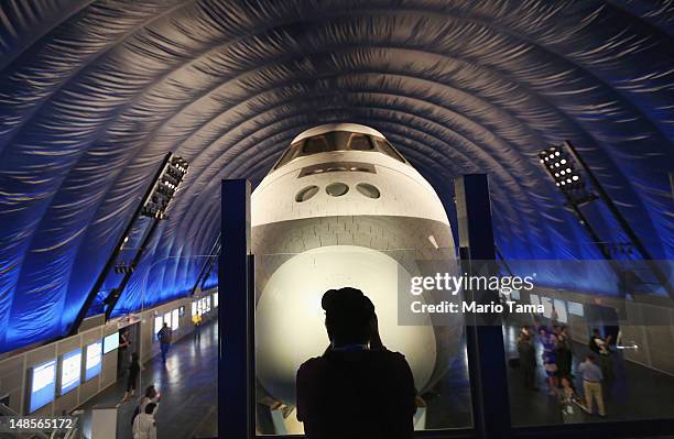 Photographer takes pictures in front of The Space Shuttle Enterprise at a press preview of the Intrepid Sea, Air & Space Museum’s new Space Shuttle...