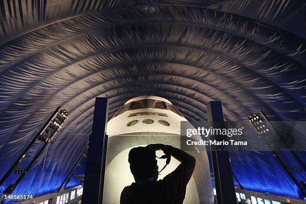 Photographer takes pictures in front of The Space Shuttle Enterprise at a press preview of the Intrepid Sea, Air & Space Museum’s new Space Shuttle...