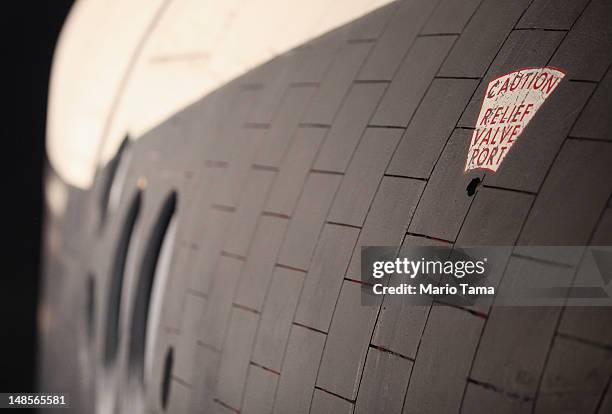 The side of the Space Shuttle Enterprise is seen at a press preview of the Intrepid Sea, Air & Space Museum’s new Space Shuttle Pavilion on July 18,...