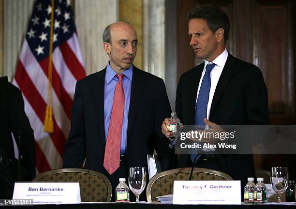 Secretary of the Treasury Timothy Geithner talks to chairman of the Commodity Futures Trading Commission Gary Gensler prior to a meeting of the...