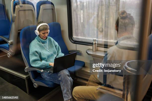 enjoying journey - working on laptop in train top view imagens e fotografias de stock