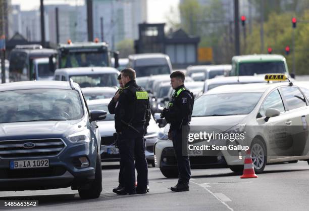 Police relegate traffic away from an intersection on Landsberger Allee where climate activists from Last Generation were blocking traffic and had...