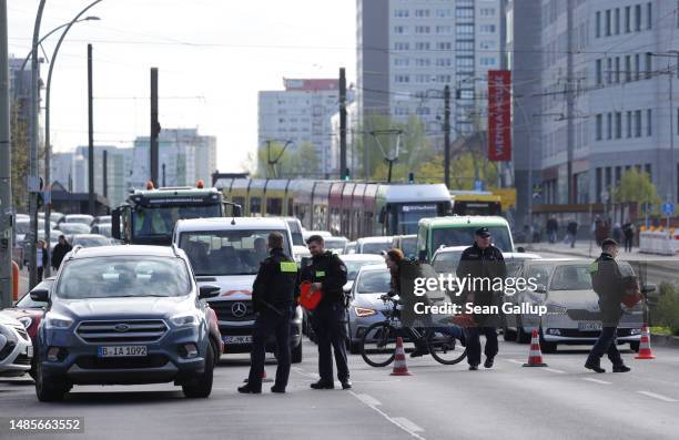 Police relegate traffic away from an intersection on Landsberger Allee where climate activists from Last Generation were blocking traffic and had...