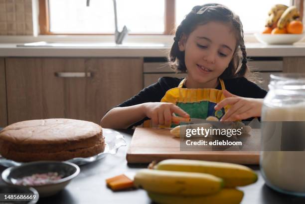 cute girl making a cake - banana cream cake stock pictures, royalty-free photos & images