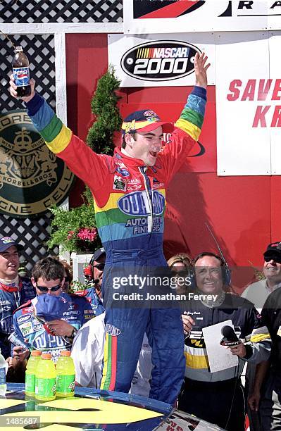Jeff Gordon celebrates his win with a Pepsi after the Save Mart/Kragen 350 presented by NAPA, part of the NASCAR Winston Cup Series at the Sears...