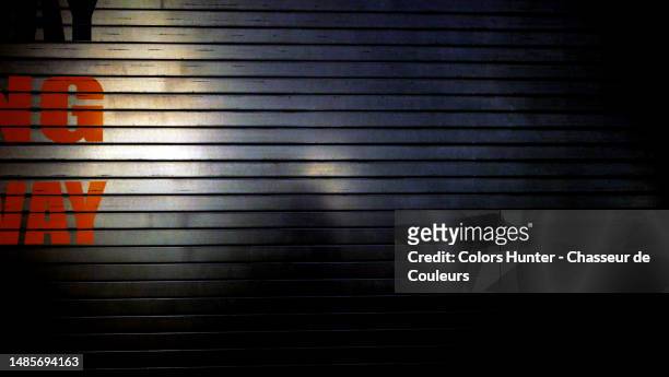 between light and shadow, close-up of a rolling garage door with painted letter at night in manhattan, new york, usa - hunter, new york stock-fotos und bilder
