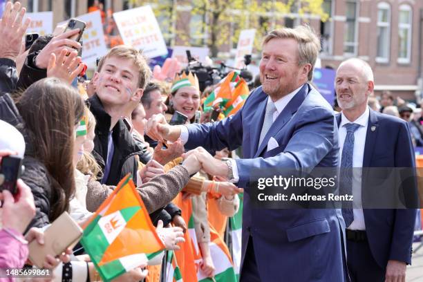 King Willem-Alexander of The Netherlands interacts with members of the public during Kingsday celebrations on April 27, 2023 in Rotterdam,...