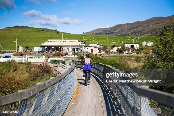 at the end of the otago central rail trail in hyde, the otago central hotel waits for the bicycle riders who stop for food and drink - otago peninsula stock pictures, royalty-free photos & images