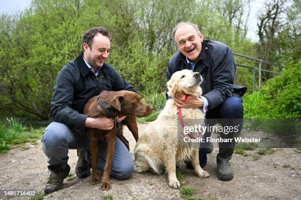 Leader of the Liberal Democrat Party Ed Davey with 'Tess' and Danny Chambers, Liberal Democrat candidate for Winchester and vet with 'Milo' pose for...