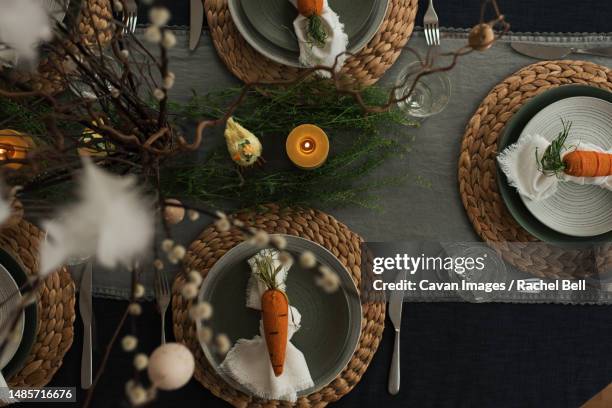 easter dinner table decorated ready for a family celebration - table setting design scandinavian stockfoto's en -beelden