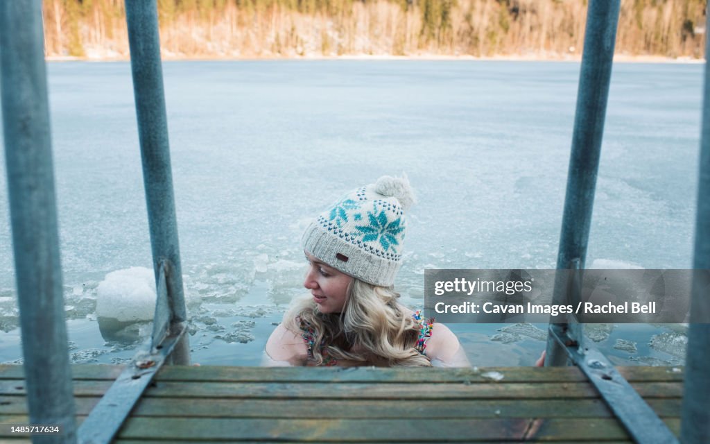 Woman cold water swimming in the frozen Baltic Sea