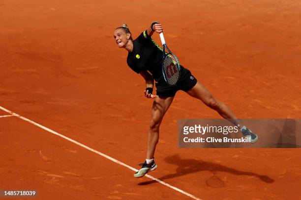 Arantxa Rus of Netherlands serves against Maria Sakkari of Greece during the Women's Singles Second Round on Day Four of the Mutua Madrid Open at La...