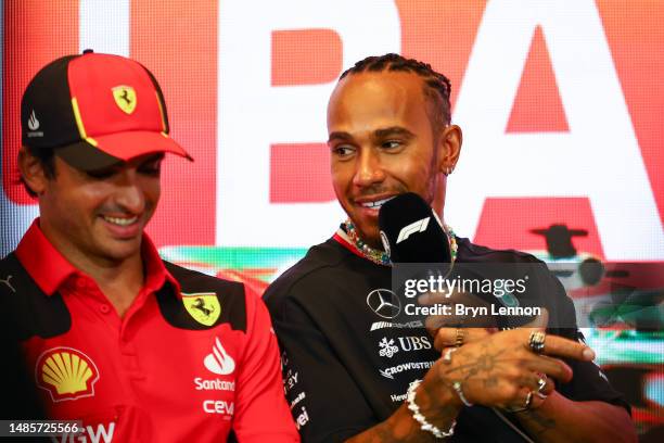 Lewis Hamilton of Great Britain and Mercedes and Carlos Sainz of Spain and Ferrari talk in a press conference during previews ahead of the F1 Grand...
