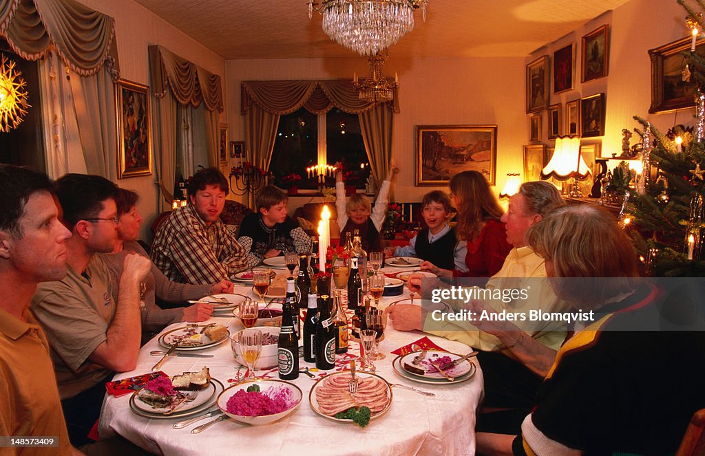 Family at table for traditional Christmas dinner.