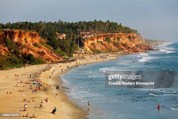 papanasham beach ringed by red laterite cliffs. - varkala beach stock pictures, royalty-free photos & images