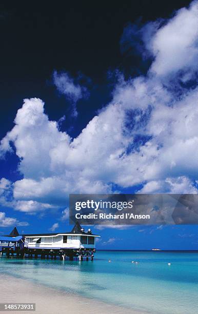 restaurant at end of pier on dickenson bay. - dickenson bay stock pictures, royalty-free photos & images