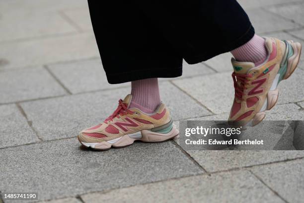 Guest wears navy blue denim large short pants, pale pink ribbed socks, pale yellow suede / pink fabric laces sneakers from New Balance , outside the...