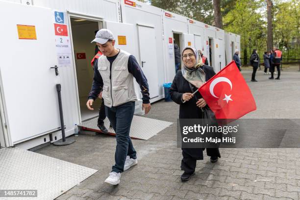 Expat Turkish citizens leave after casting a vote at the Turkish Consulate General during early voting in Turkish general elections on April 27, 2023...