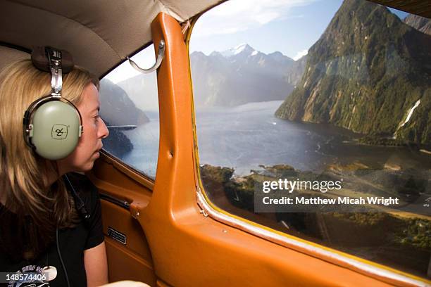 tourist looking at scenery from light plane. - helicopter window stock pictures, royalty-free photos & images