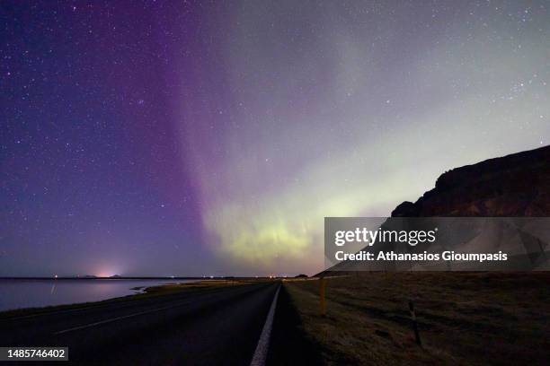 Northern lights or aurora polar lights up the sky on April 16, 2023 in Vik, Iceland.